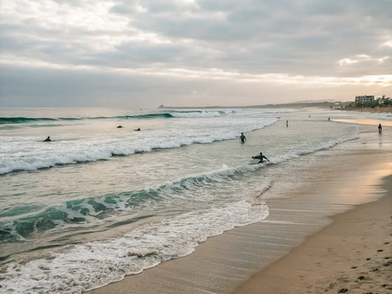 A scenic shot of the meeting location, showcasing a picturesque beach with calm waters and the 2EZ Waves branded stand, making it easy for participants to find the starting point.